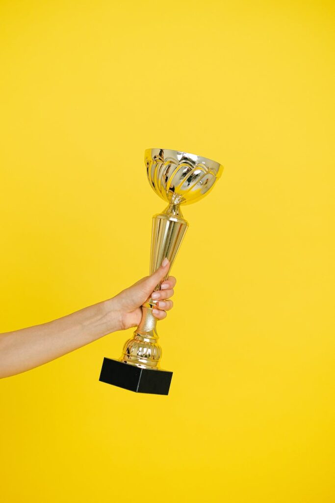 close up photo of person holding a trophy